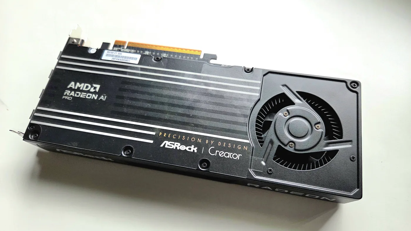 An AMD Radeon AI PRO R9700 graphics card, 32 GB, seen from the back — the ASRock Creator model.